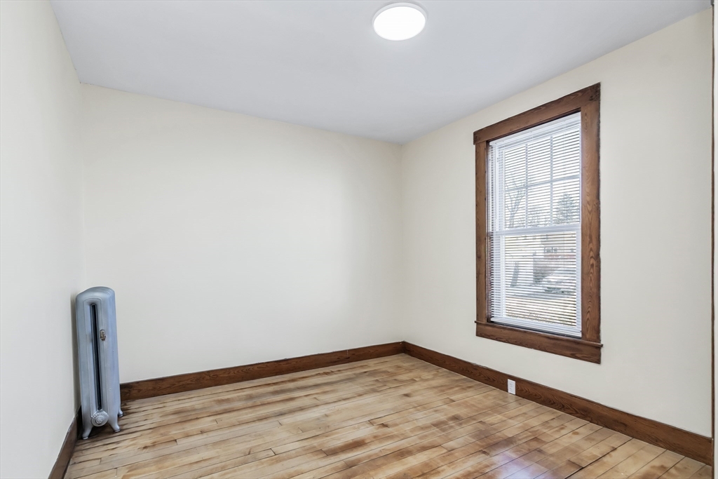 144 A Street Lowell, MA 01851 - Photo 23 of 32 a view of an empty room with wooden floor and a window