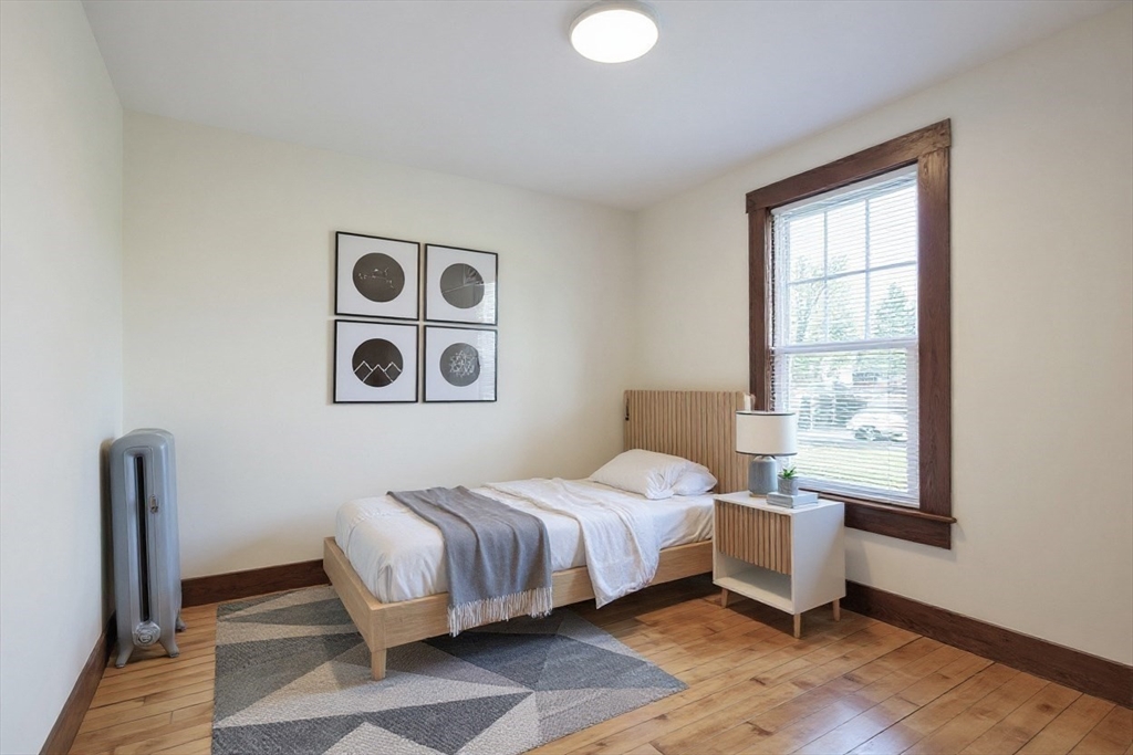 144 A Street Lowell, MA 01851 - Photo 24 of 32 a bedroom with a bed and a window