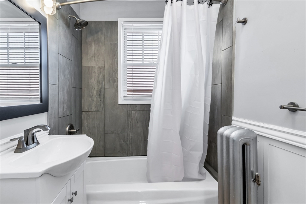 144 A Street Lowell, MA 01851 - Photo 30 of 32 a bathroom with a sink a toilet and shower