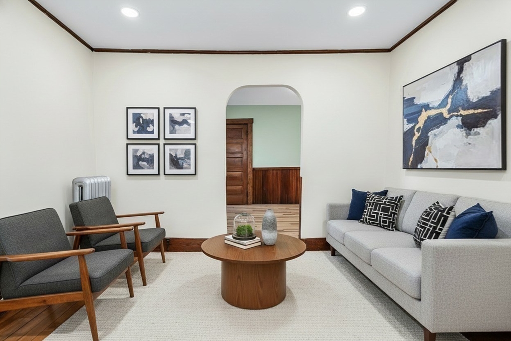 144 A Street Lowell, MA 01851 - Photo 8 of 32 a living room with furniture and a potted plant