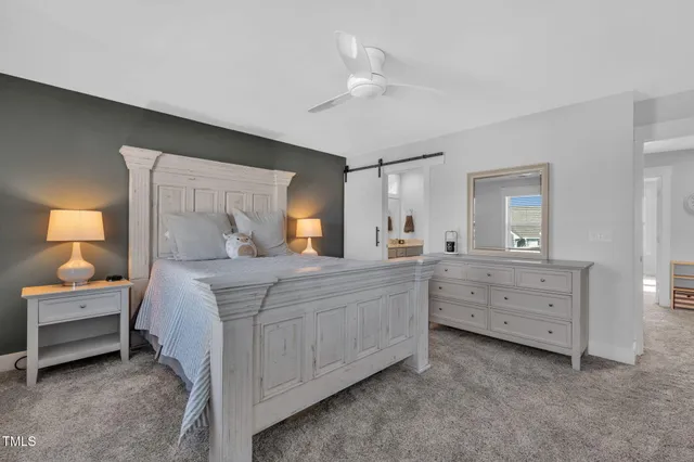 a bedroom with a bed and a dresser