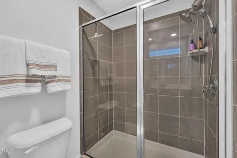 a bathroom with a shower and toilet