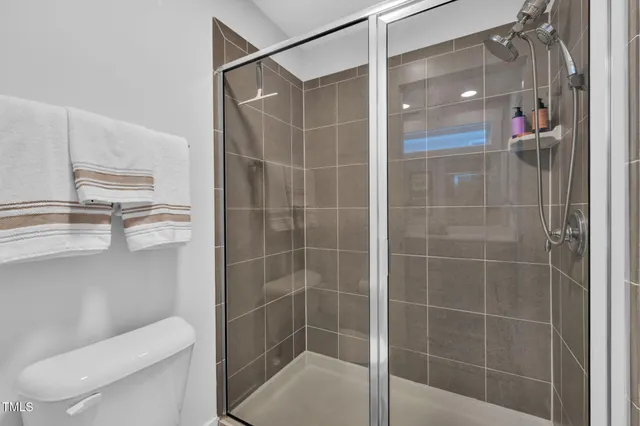 a bathroom with a shower and toilet