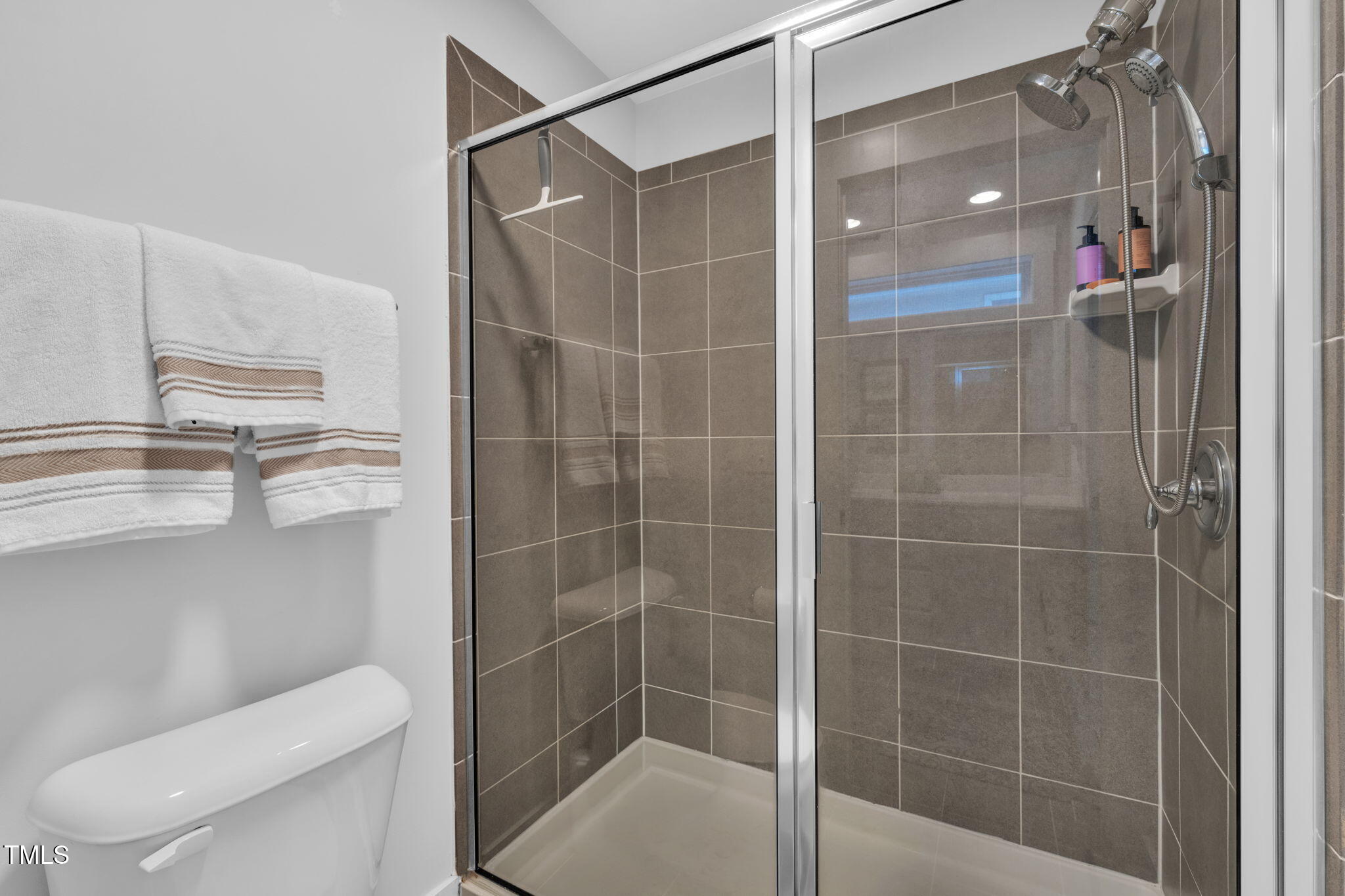 257 Douglas Falls Drive Wendell, NC 27591 - Photo 16 of 34 a bathroom with a shower and toilet