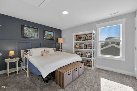 a bed sitting in a bedroom next to a window