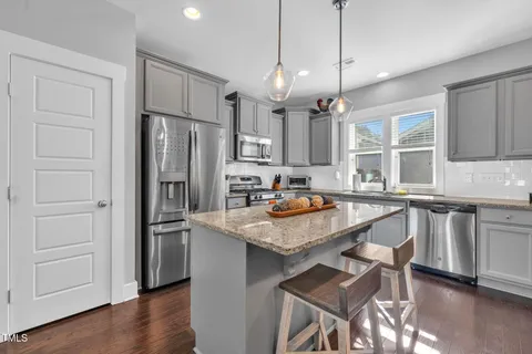 a living room with furniture a rug and a chandelier