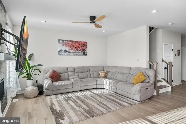 a living room with furniture and wooden floor