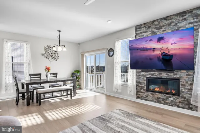 a living room with furniture a dining table and a fireplace