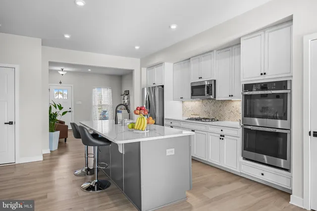 a kitchen that has a lot of cabinets in it and appliances