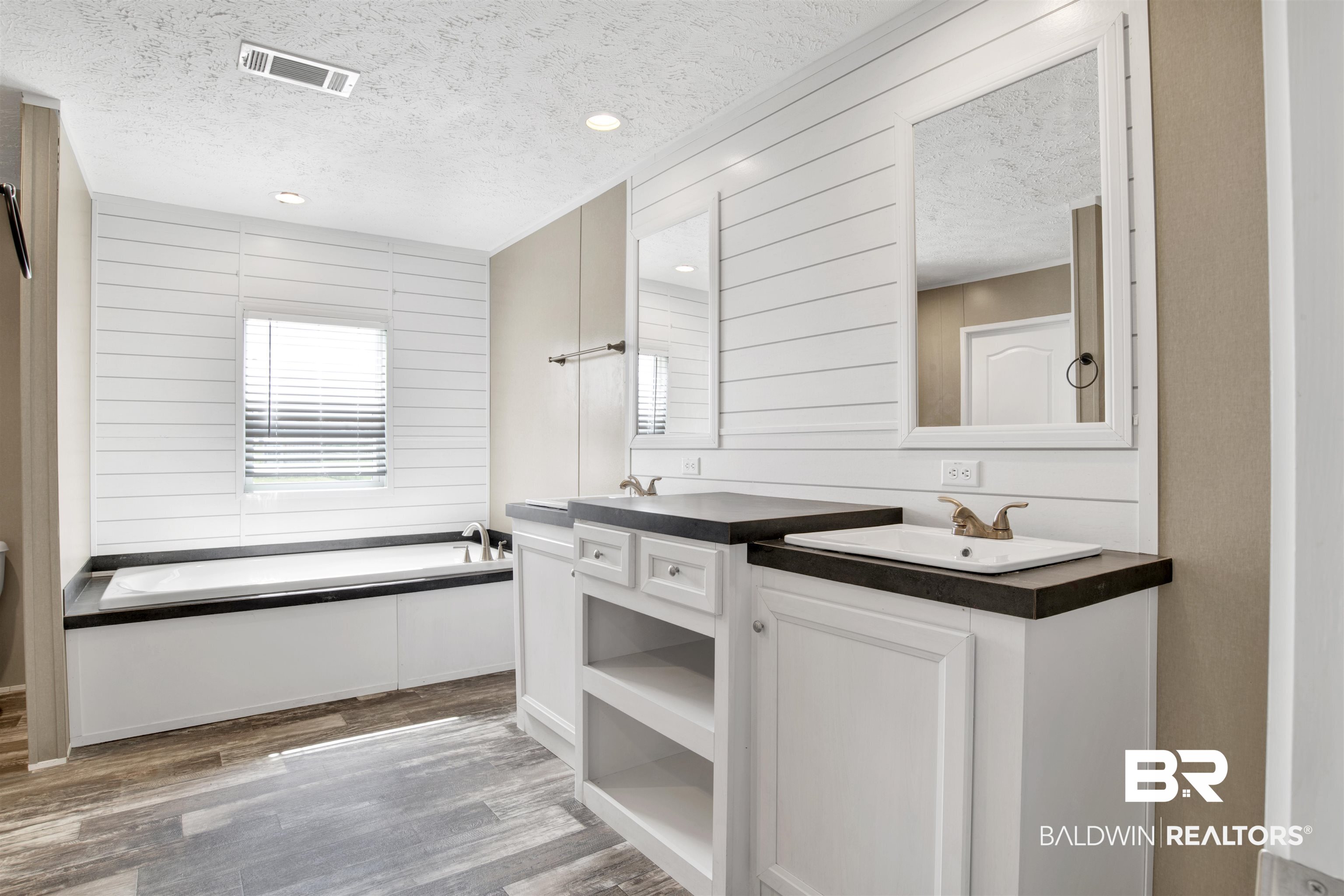 16778 County Road 87 Elberta, AL 36530 - Photo 21 of 32 Bathroom with hardwood / wood-style flooring, a tub to relax in, vanity, and a textured ceiling