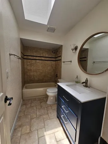 a bathroom with a sink a toilet and tub