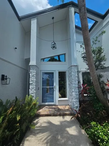 a front view of a house with a garden