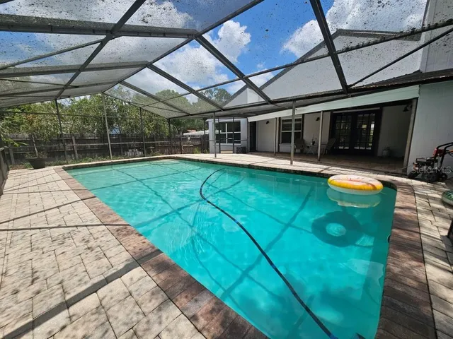 a view of a swimming pool with a patio