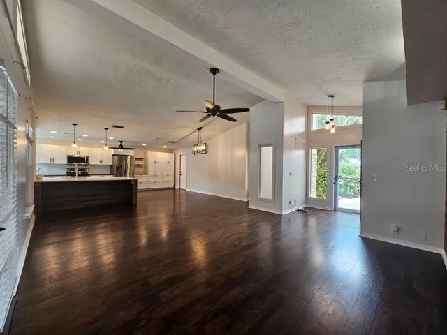 a view of a kitchen with a stove wooden floor and a kitchen