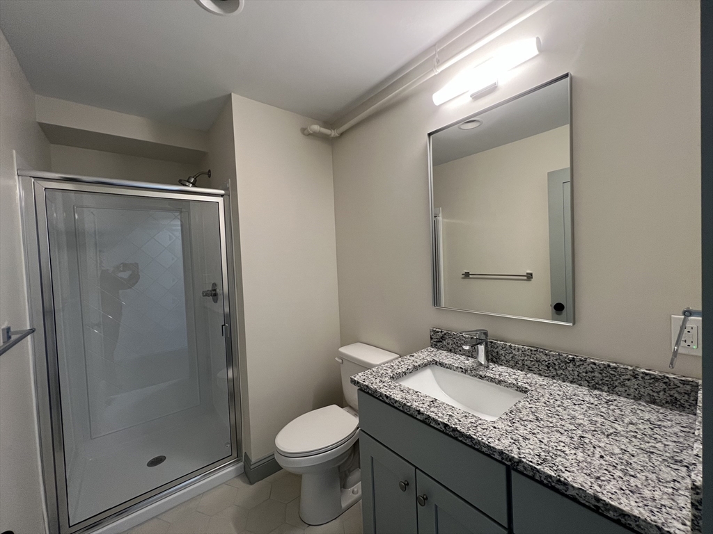 160 Seabury Street, Unit 40 Fall River, MA 02720 - Photo 12 of 14 a bathroom with a granite countertop sink toilet and shower