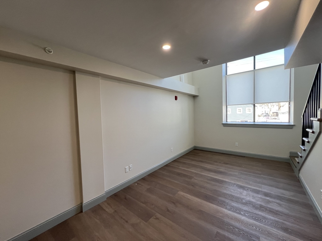 160 Seabury Street, Unit 40 Fall River, MA 02720 - Photo 3 of 13 a view of an empty room with wooden floor and a window