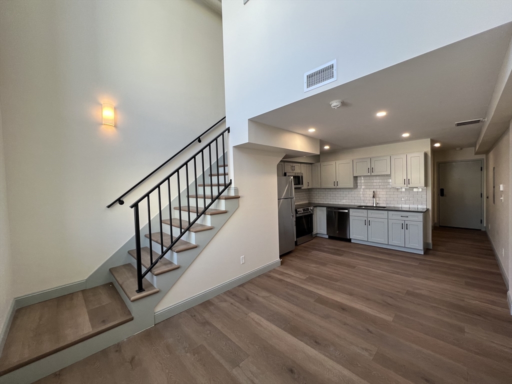 160 Seabury Street, Unit 40 Fall River, MA 02720 - Photo 6 of 13 a view of kitchen and kitchen with furniture wooden floor and window