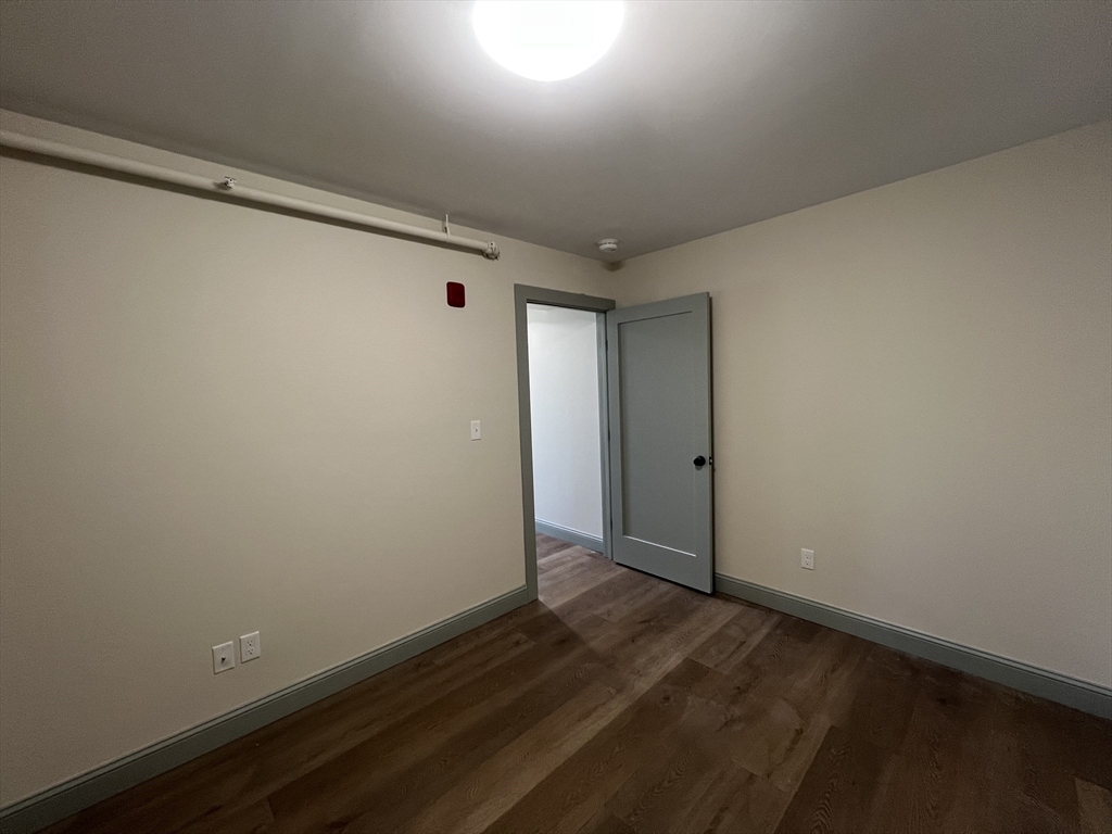 160 Seabury Street, Unit 40 Fall River, MA 02720 - Photo 9 of 13 an empty room with wooden floor