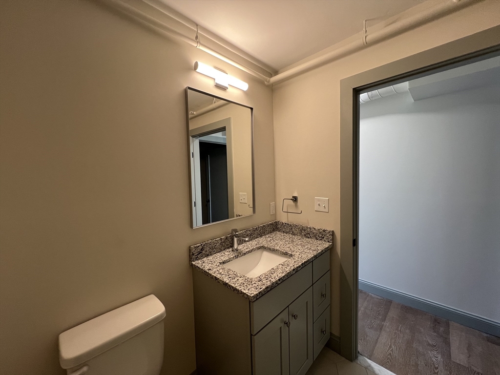 160 Seabury Street, Unit 40 Fall River, MA 02720 - Photo 10 of 13 a bathroom with a granite countertop sink and a mirror