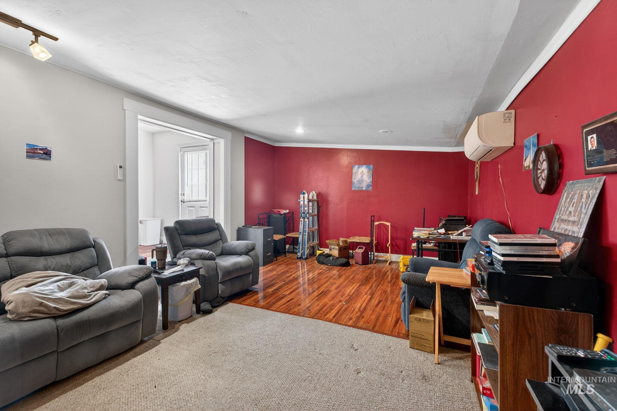 208 South 4th W Street Preston, ID 83263 - Photo 15 of 38 Living area featuring an AC wall unit and wood finished floors