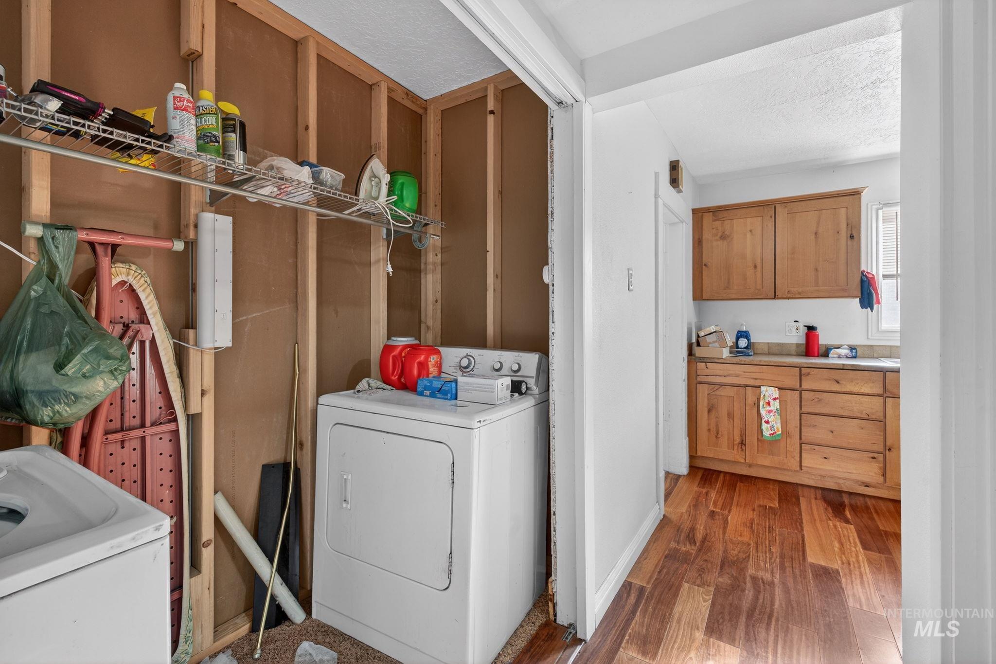 208 South 4th W Street Preston, ID 83263 - Photo 20 of 38 Laundry room with dark wood finished floors and a textured ceiling
