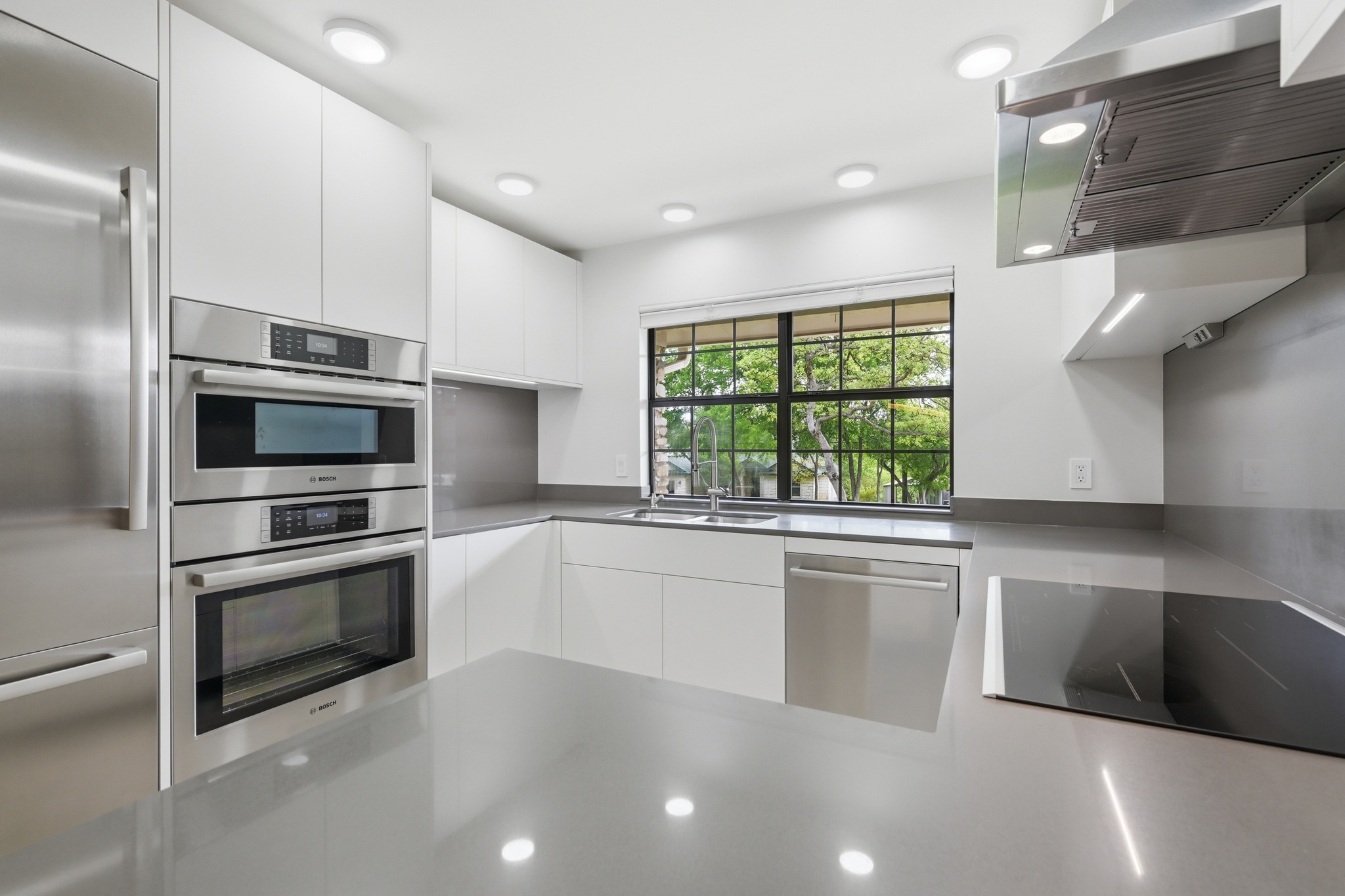 320 Ridgecrest Road Georgetown, TX 78628 - Photo 11 of 39 a large kitchen with stainless steel appliances granite countertop a stove a sink and a microwave