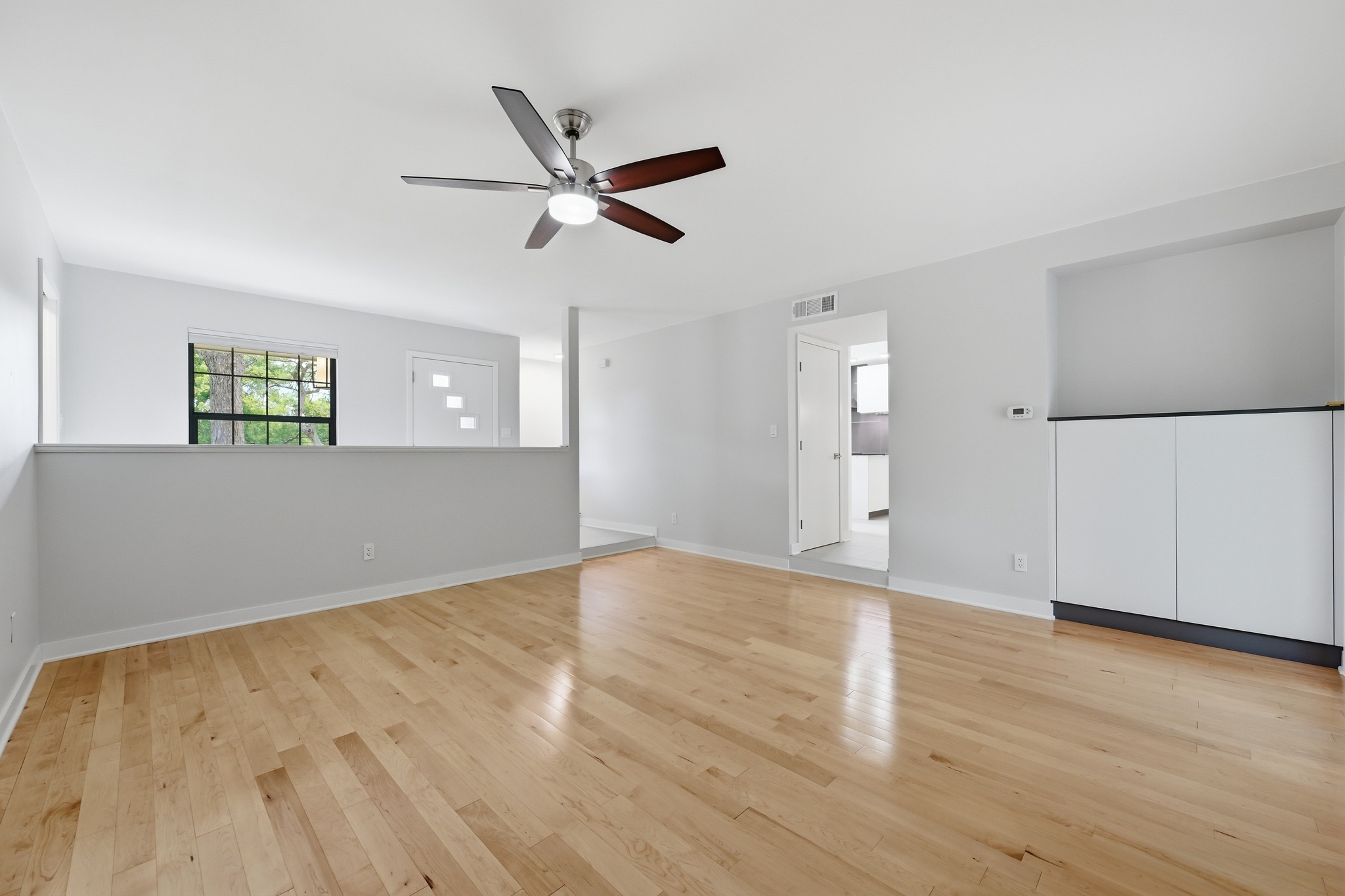 320 Ridgecrest Road Georgetown, TX 78628 - Photo 9 of 39 a view of an empty room with wooden floor and a window