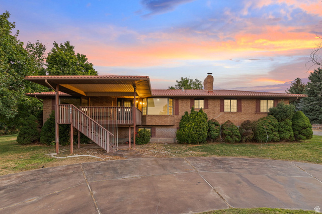 875 Cedar Hollow Road Lehi, UT 84043 - Photo 72 of 76 Brick exterior with a tiled roof, covered deck, and an expansive driveway