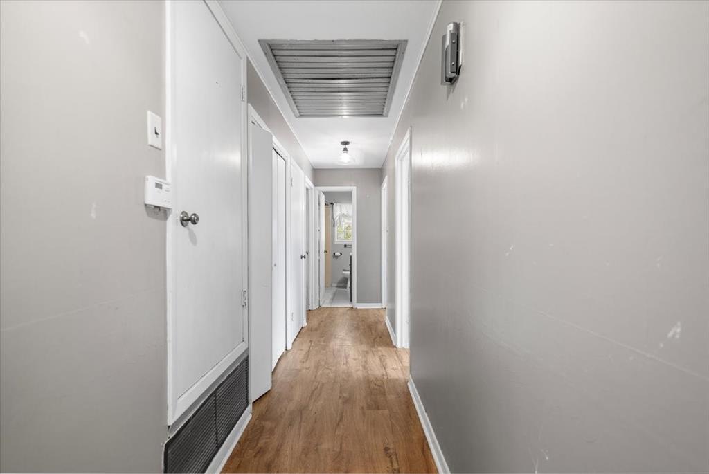 511 Happy Mount Mount Pleasant, TX 75455 - Photo 13 of 37 a view of a hallway with wooden floor and staircase