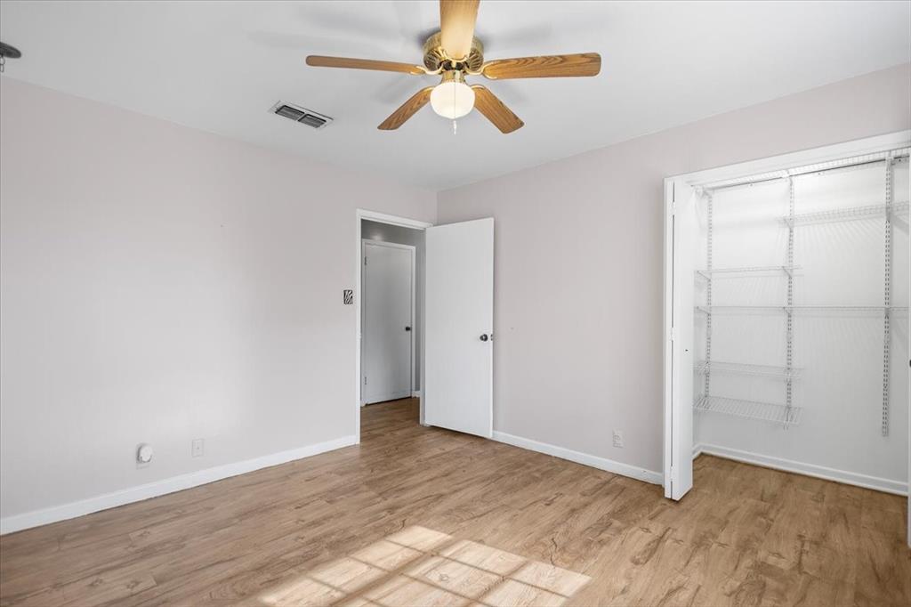 511 Happy Mount Mount Pleasant, TX 75455 - Photo 16 of 37 wooden floor in an empty room with a window