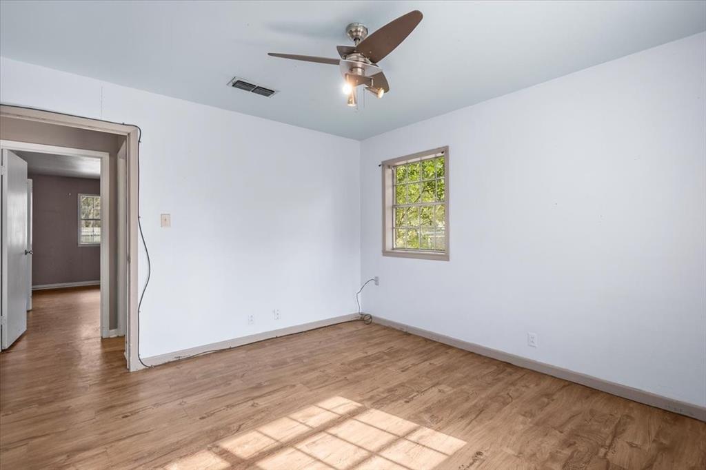 511 Happy Mount Mount Pleasant, TX 75455 - Photo 18 of 37 wooden floor in an empty room with a window
