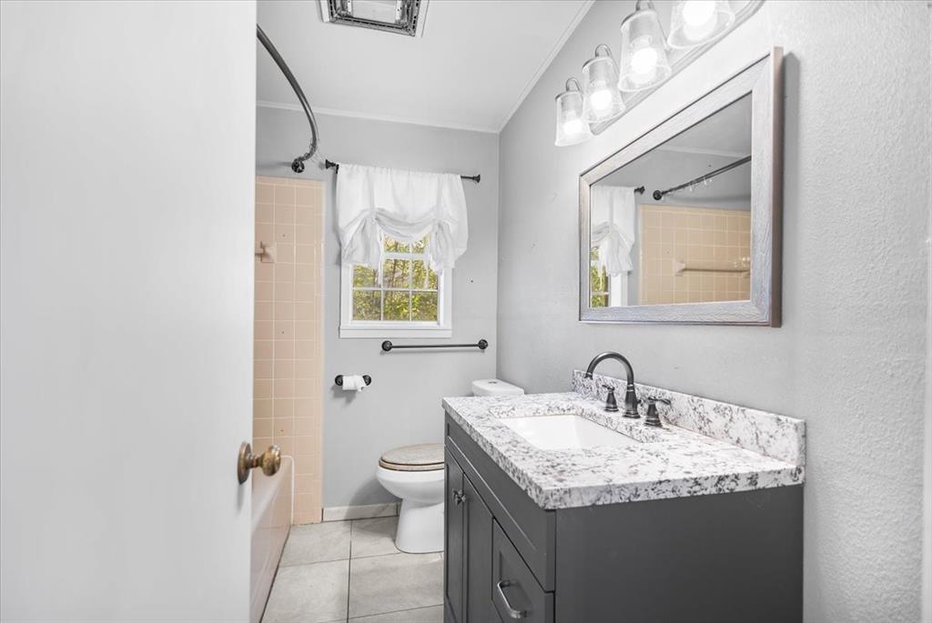 511 Happy Mount Mount Pleasant, TX 75455 - Photo 20 of 37 a bathroom with a granite countertop sink toilet and shower