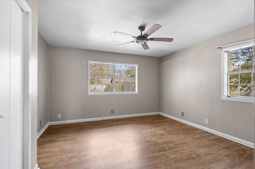 511 Happy Mount Mount Pleasant, TX 75455 - Photo 21 of 37 a view of a big room with wooden floor and windows