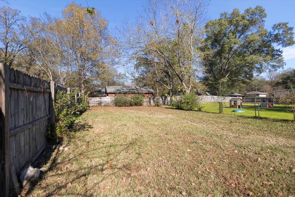 511 Happy Mount Mount Pleasant, TX 75455 - Photo 31 of 37 a view of a yard with wooden fence
