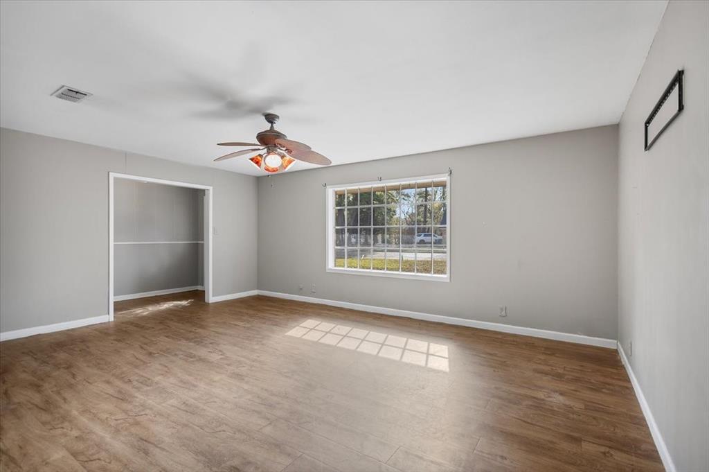 511 Happy Mount Mount Pleasant, TX 75455 - Photo 5 of 37 wooden floor in an empty room with a window