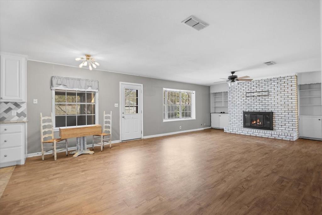 511 Happy Mount Mount Pleasant, TX 75455 - Photo 7 of 37 an empty room with furniture and a fireplace
