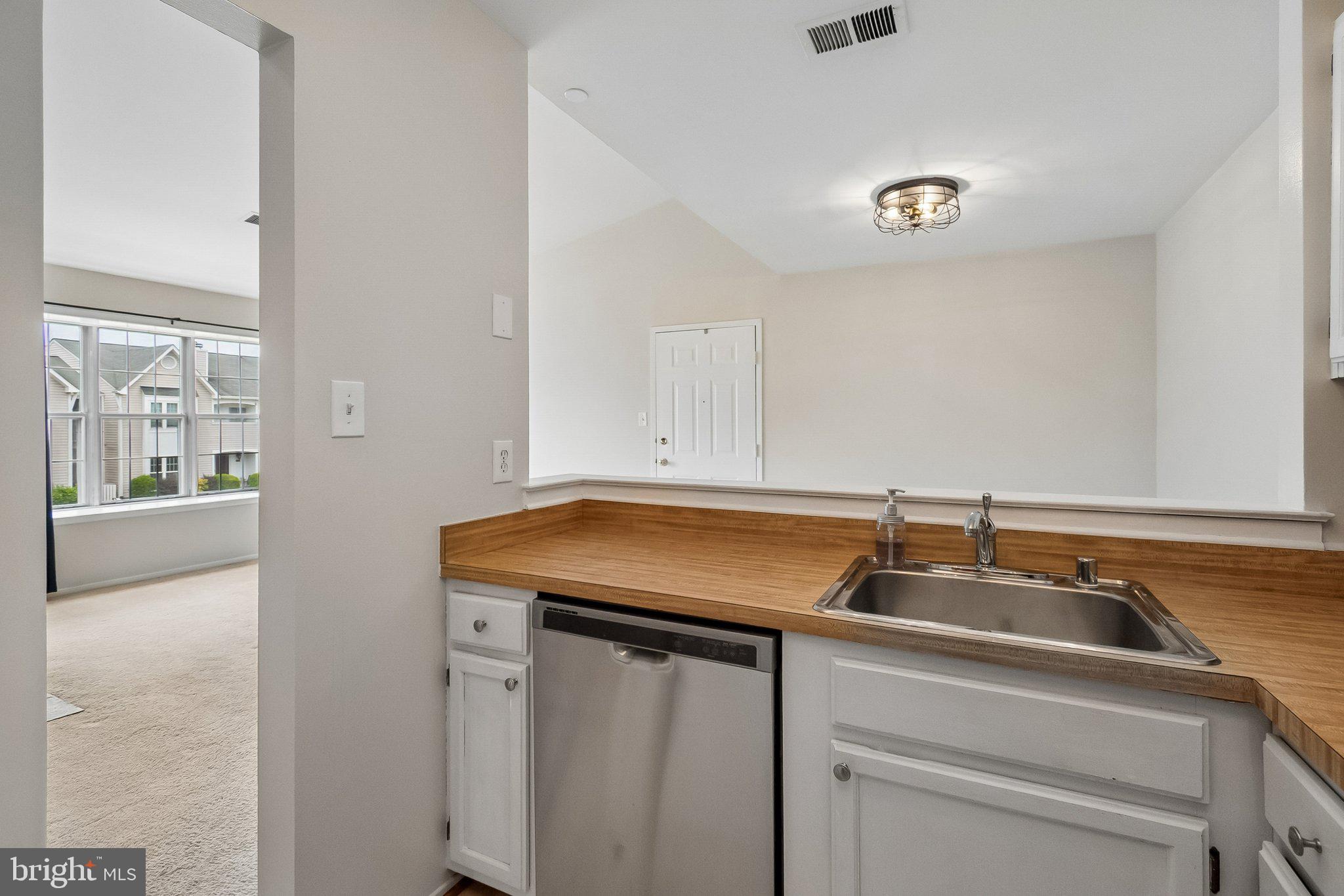 7822 Harrowgate Circle, Unit D Springfield, VA 22152 - Photo 13 of 28 Pass-through from kitchen to dining area