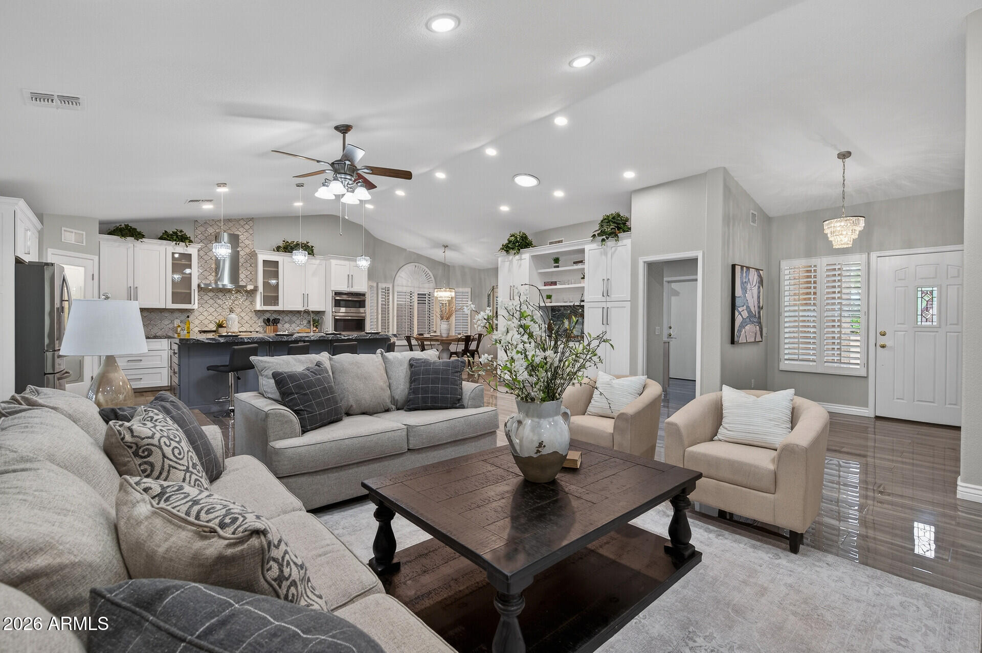 3533 North 159th Lane Goodyear, AZ 85395 - Photo 11 of 65 a living room with furniture kitchen view and a chandelier