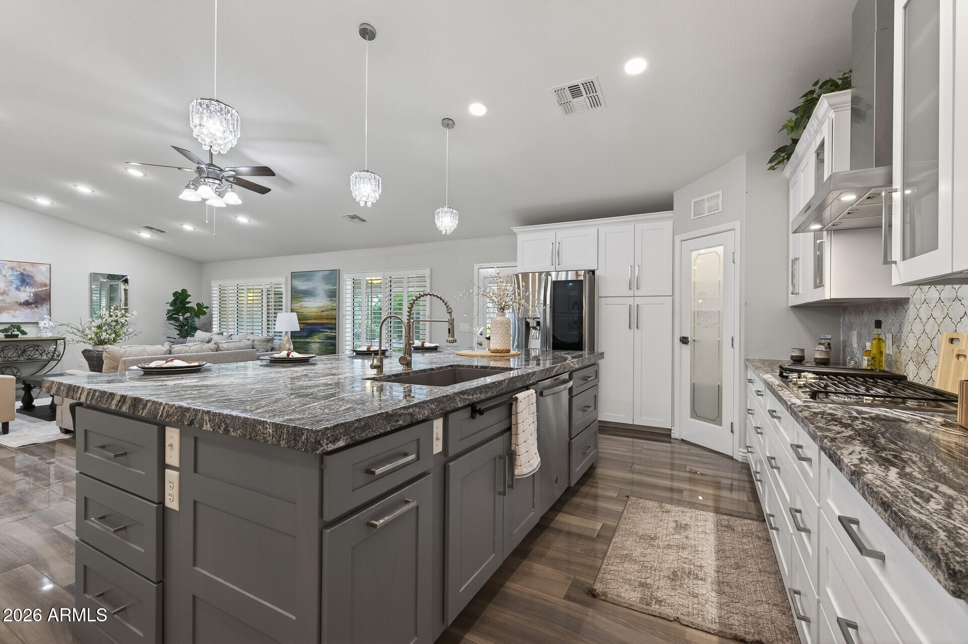3533 North 159th Lane Goodyear, AZ 85395 - Photo 18 of 65 a kitchen with stainless steel appliances granite countertop a stove oven and a refrigerator