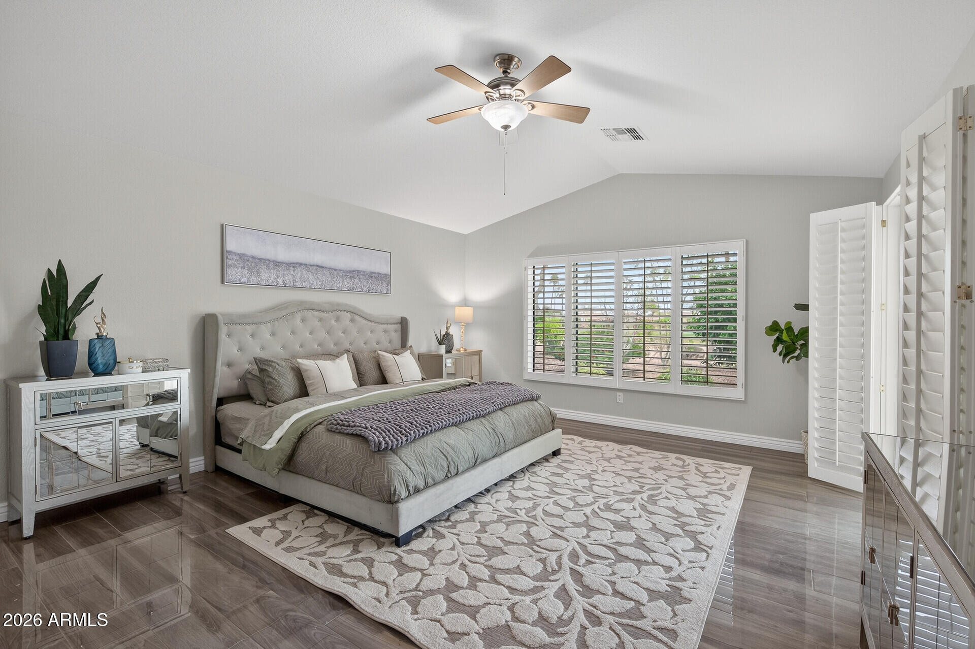 3533 North 159th Lane Goodyear, AZ 85395 - Photo 25 of 65 a bedroom with a large bed and a chandelier