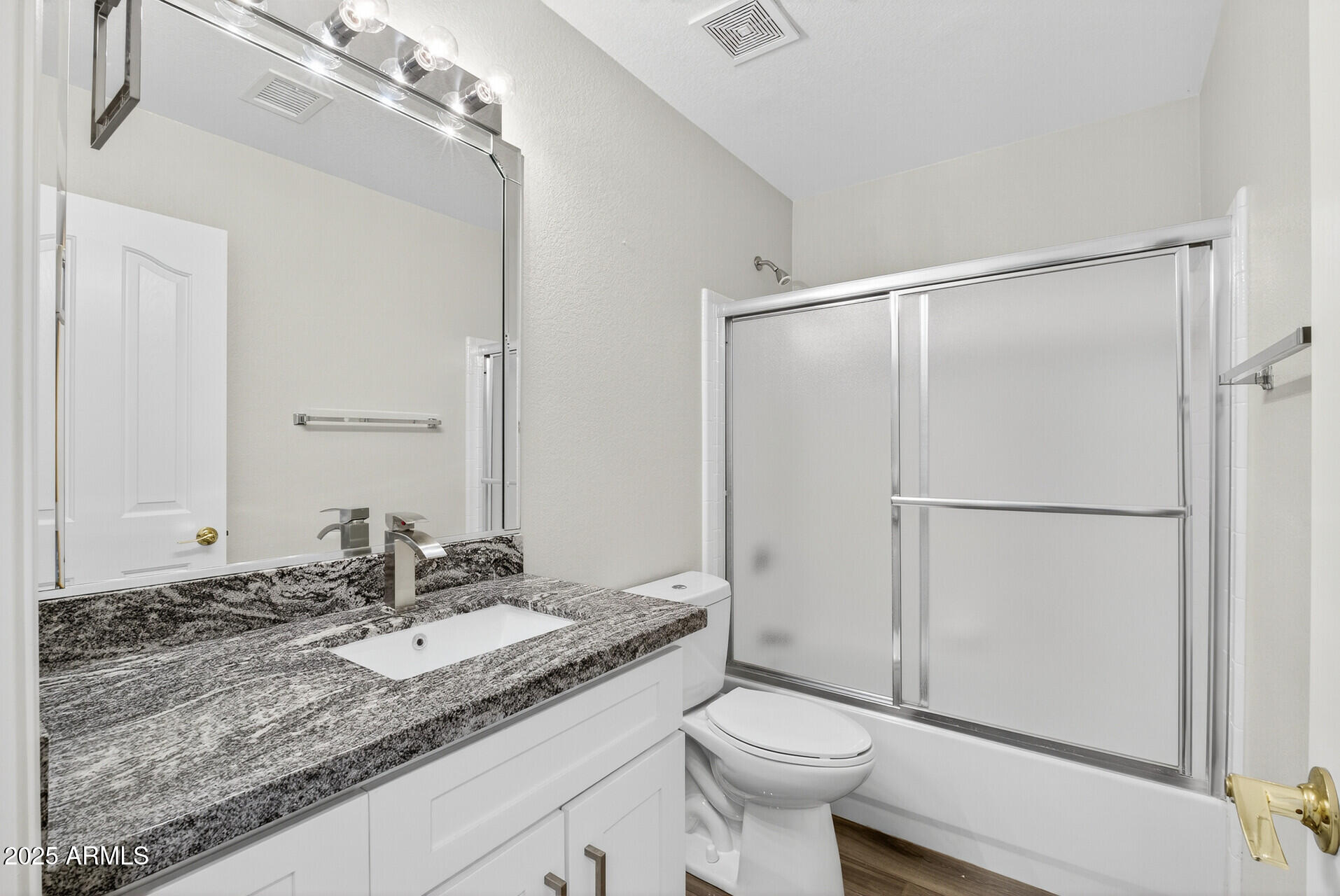 3533 North 159th Lane Goodyear, AZ 85395 - Photo 34 of 65 a bathroom with a granite countertop sink toilet and shower