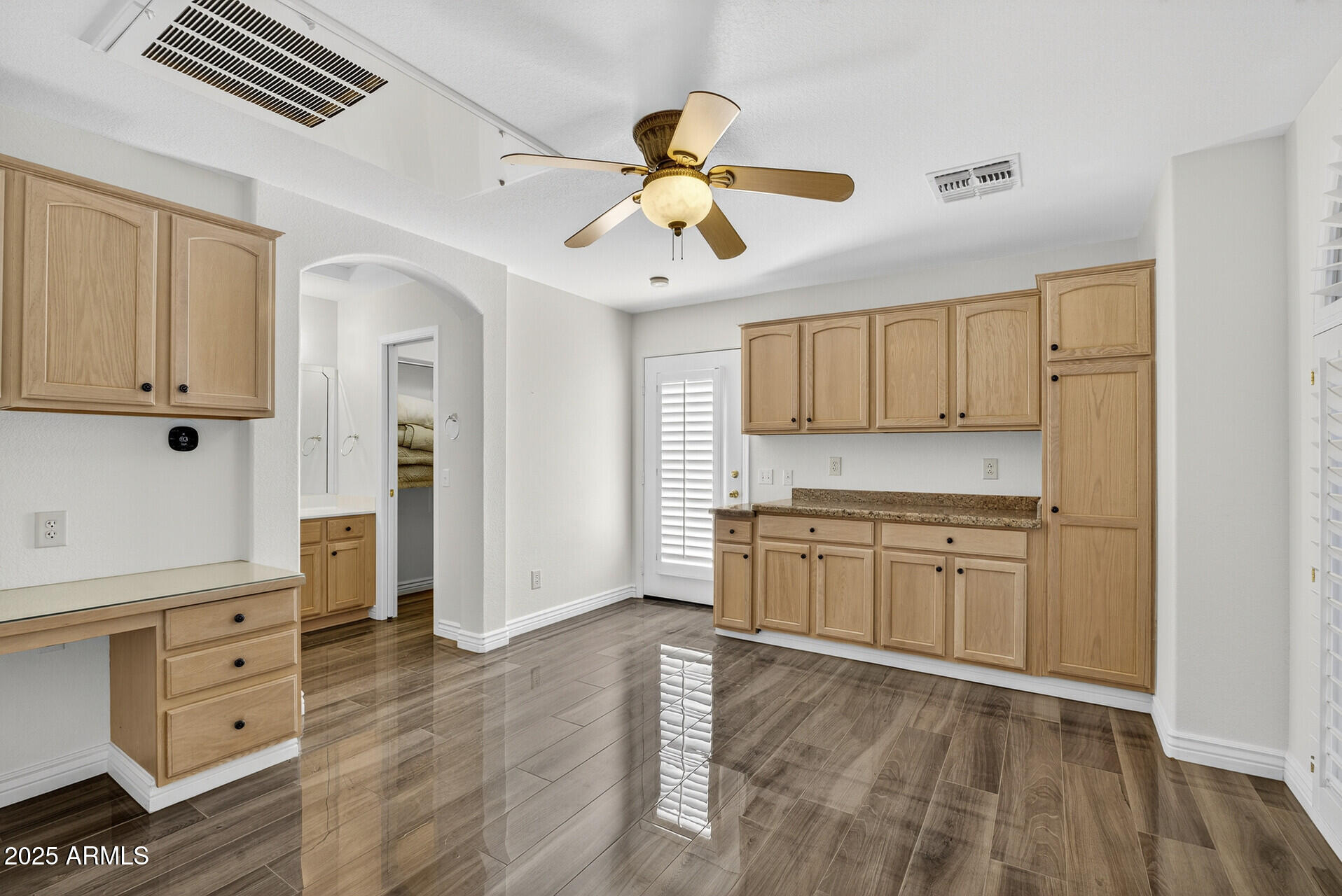 3533 North 159th Lane Goodyear, AZ 85395 - Photo 38 of 65 a kitchen with kitchen island white cabinets and window