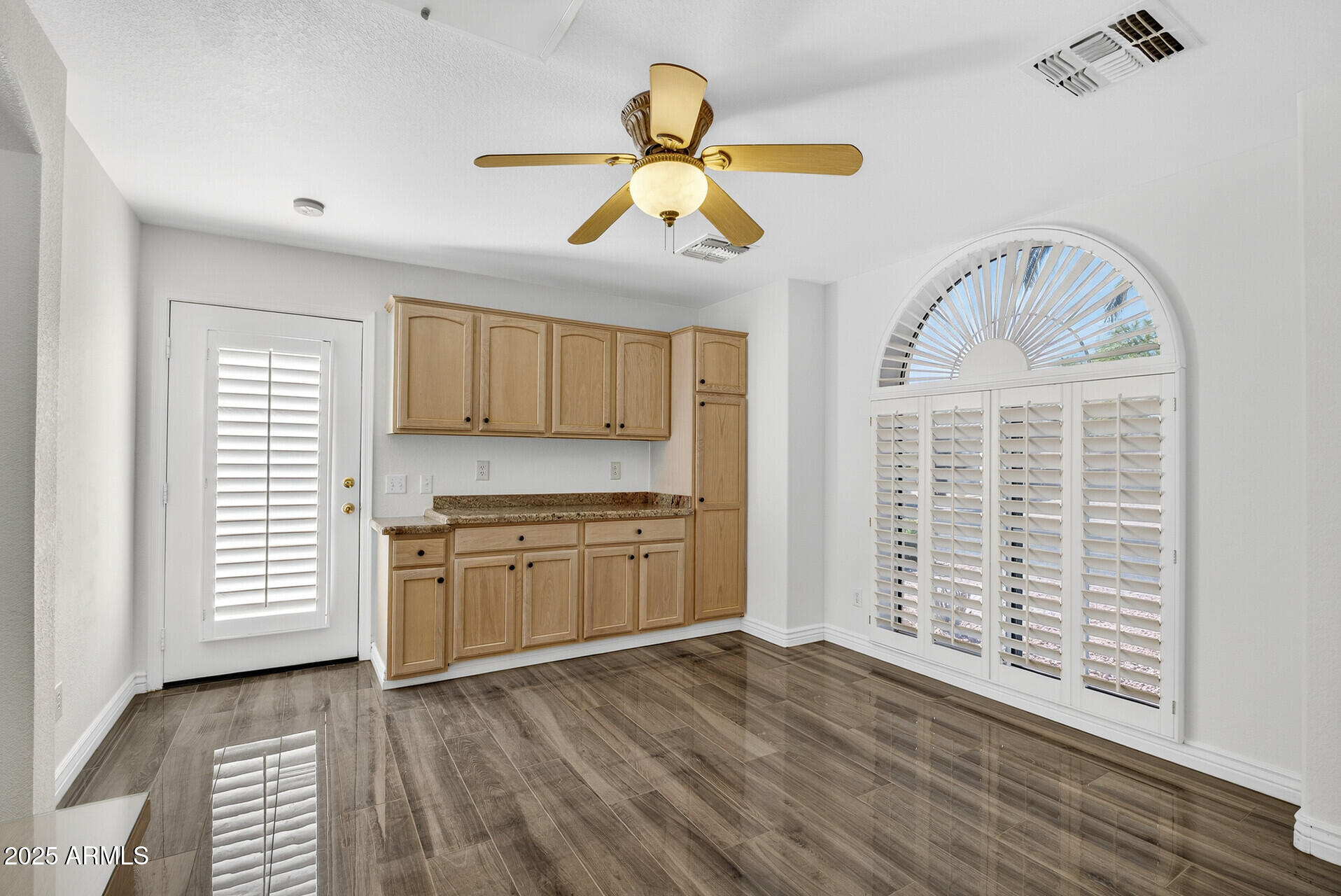 3533 North 159th Lane Goodyear, AZ 85395 - Photo 39 of 65 a view of an empty room with window and wooden floor