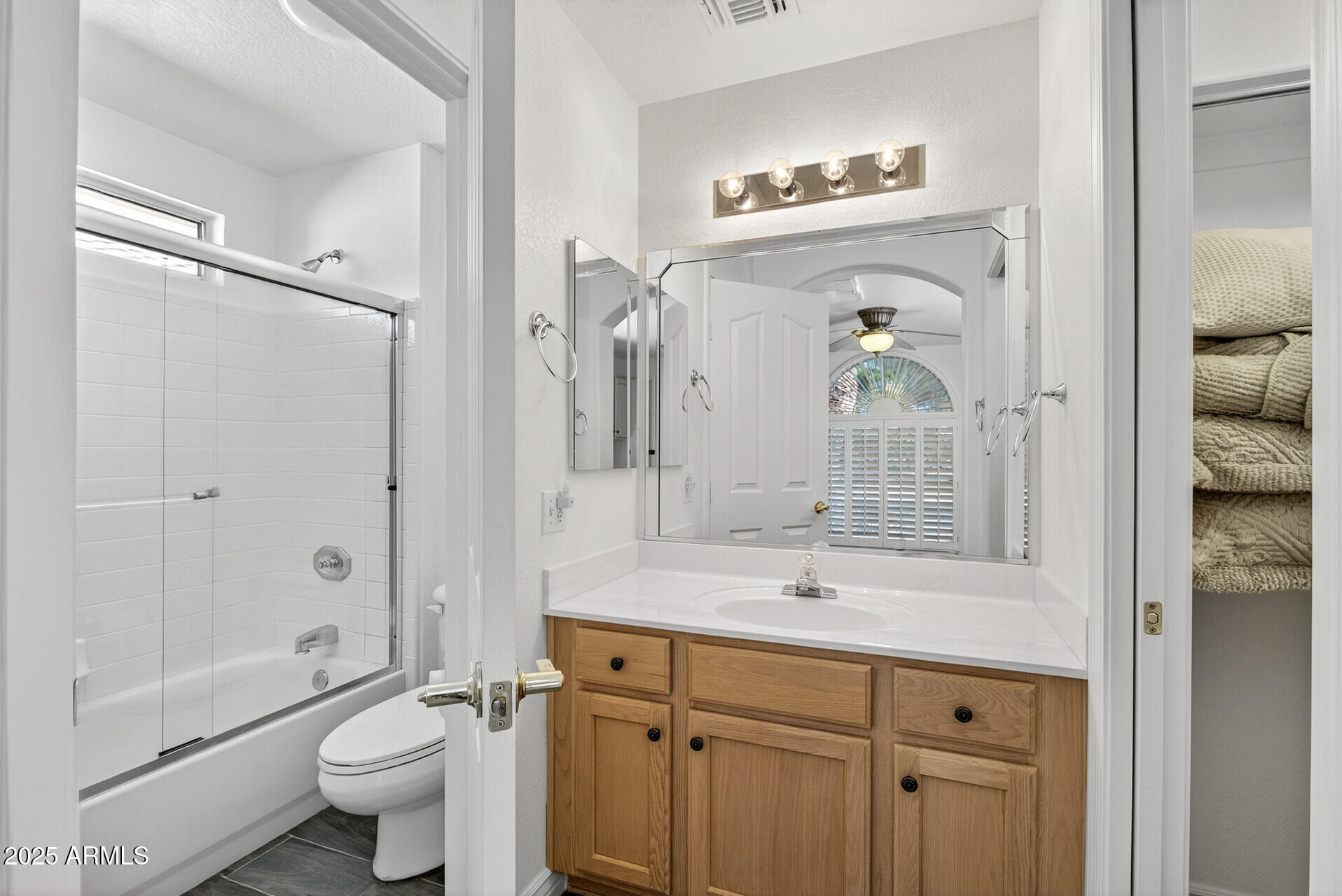 3533 North 159th Lane Goodyear, AZ 85395 - Photo 40 of 65 a bathroom with a sink a toilet and a large mirror