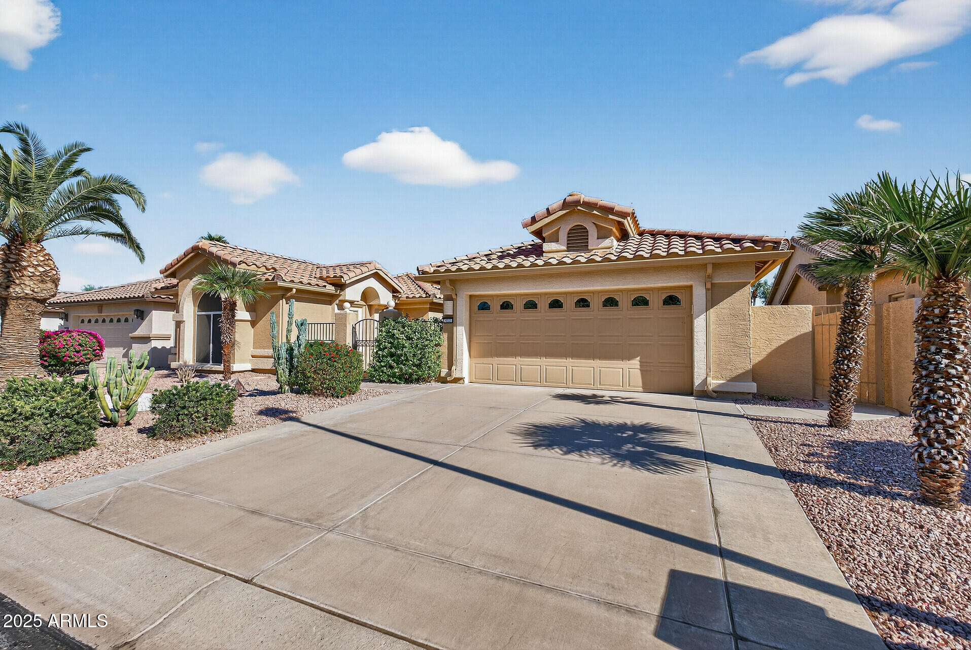 3533 North 159th Lane Goodyear, AZ 85395 - Photo 4 of 65 a front view of a house with a yard and glass top table and chair
