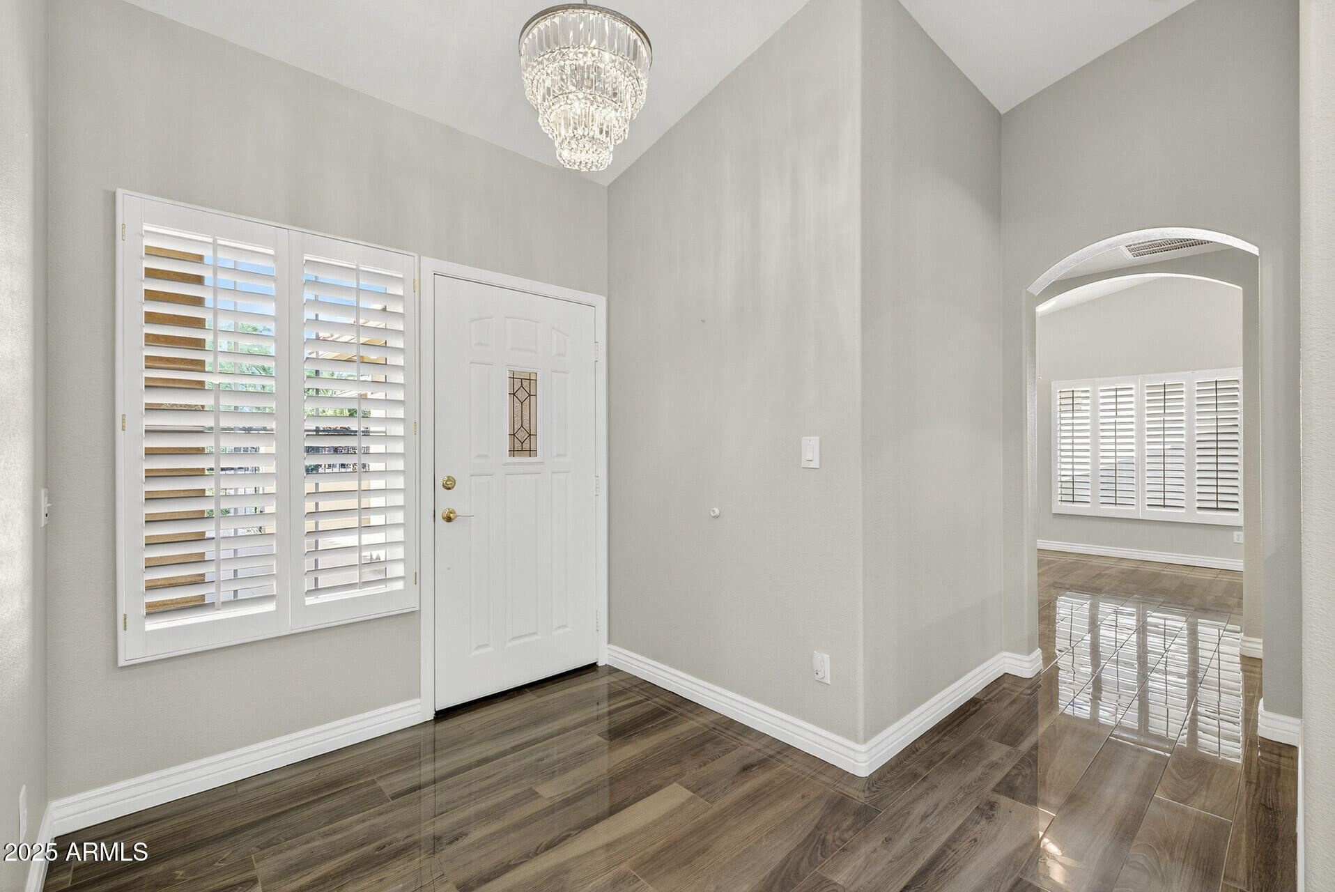 3533 North 159th Lane Goodyear, AZ 85395 - Photo 8 of 65 a view of an empty room with wooden floor and a window