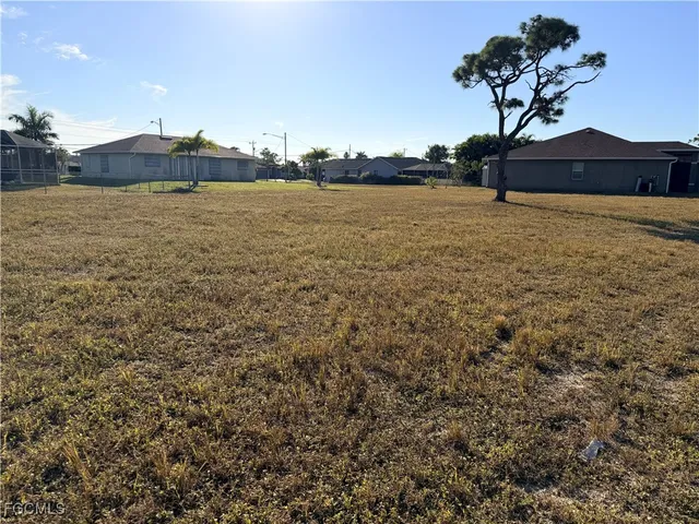 a swimming pool with lawn chairs and a yard