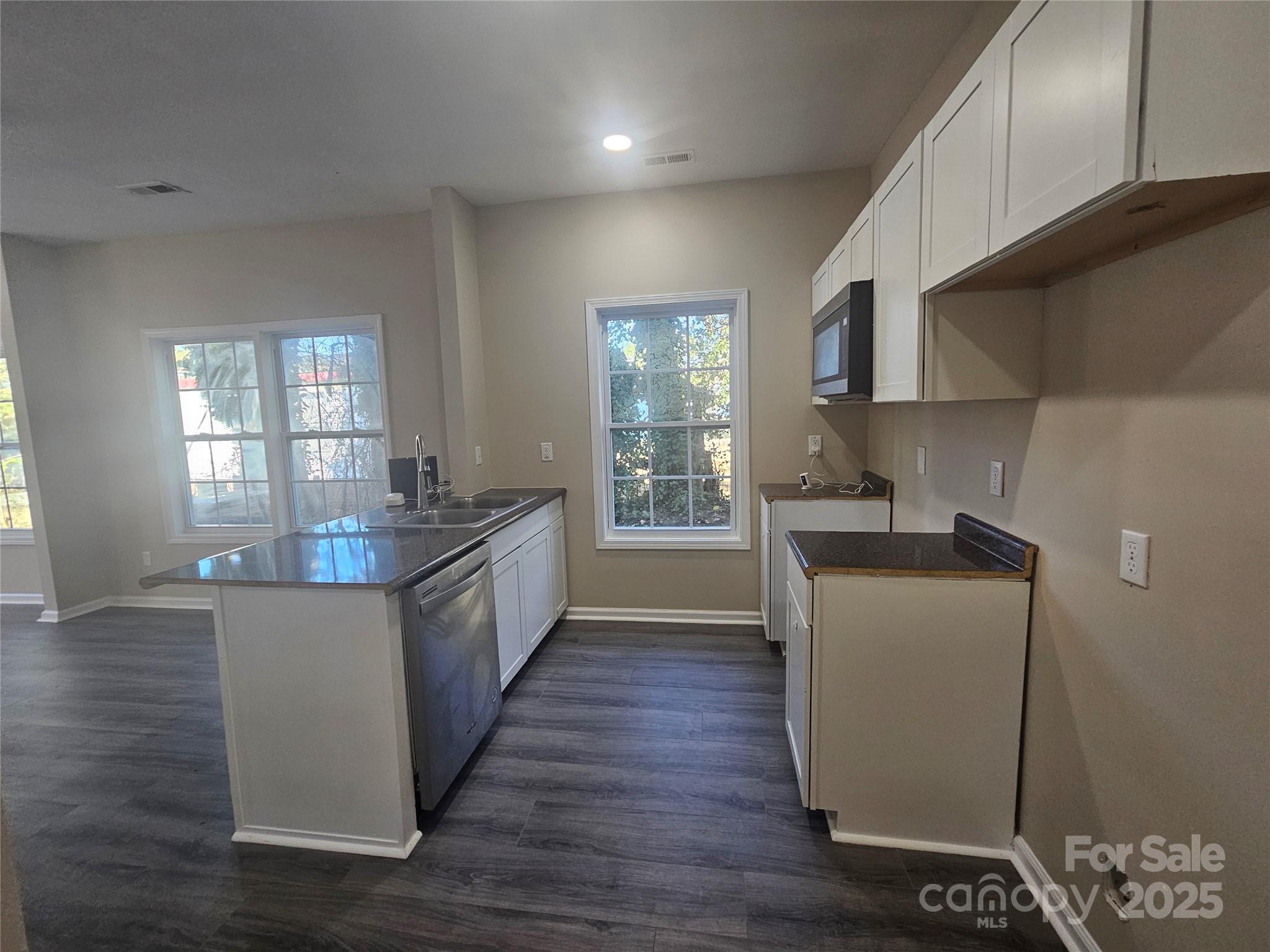 106 Steinkuhler Street, Unit 6 Chester, SC 29706 - Photo 16 of 25 a kitchen with granite countertop a sink a counter space and cabinets