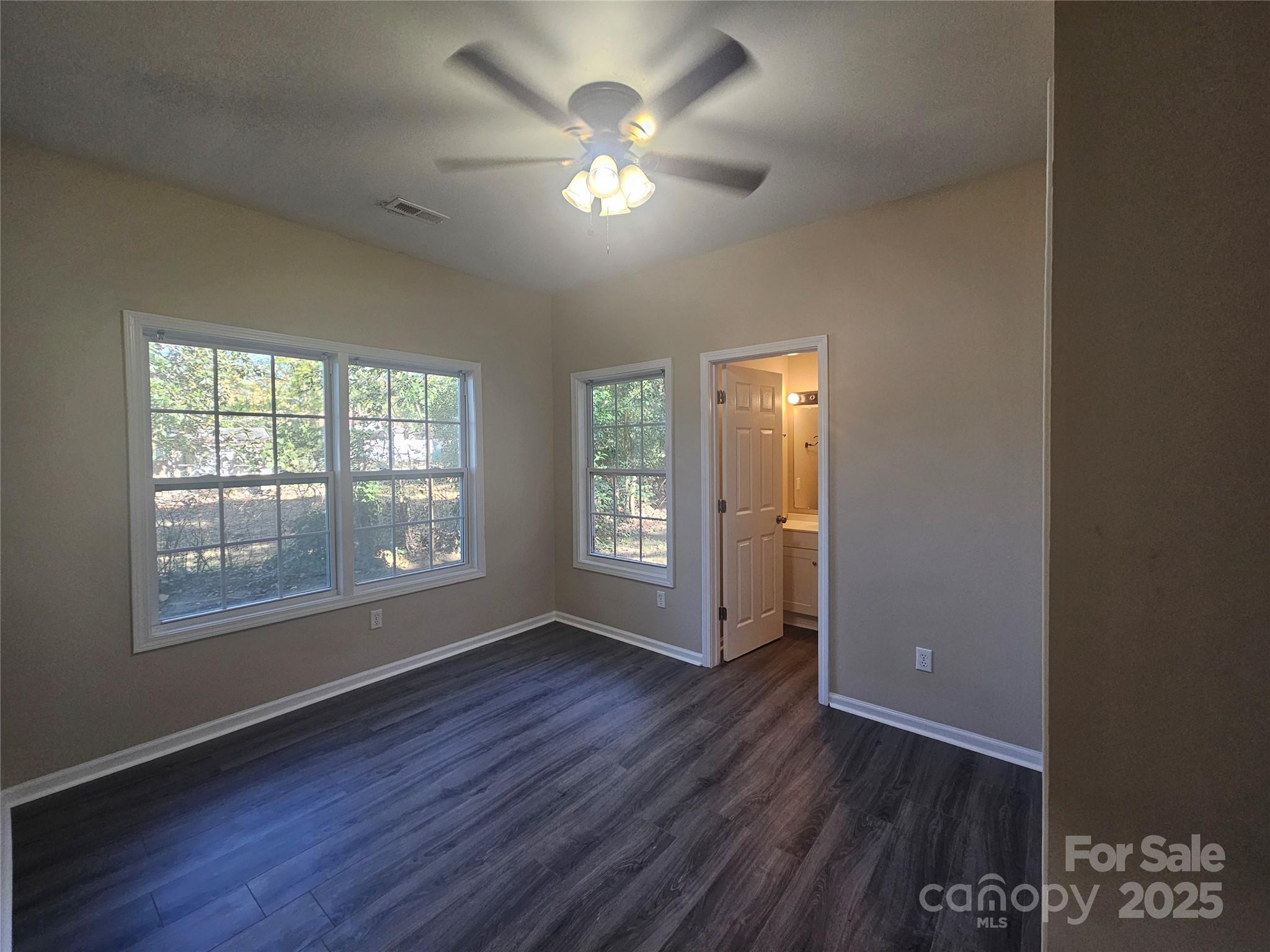 106 Steinkuhler Street, Unit 6 Chester, SC 29706 - Photo 17 of 25 an empty room with wooden floor and windows