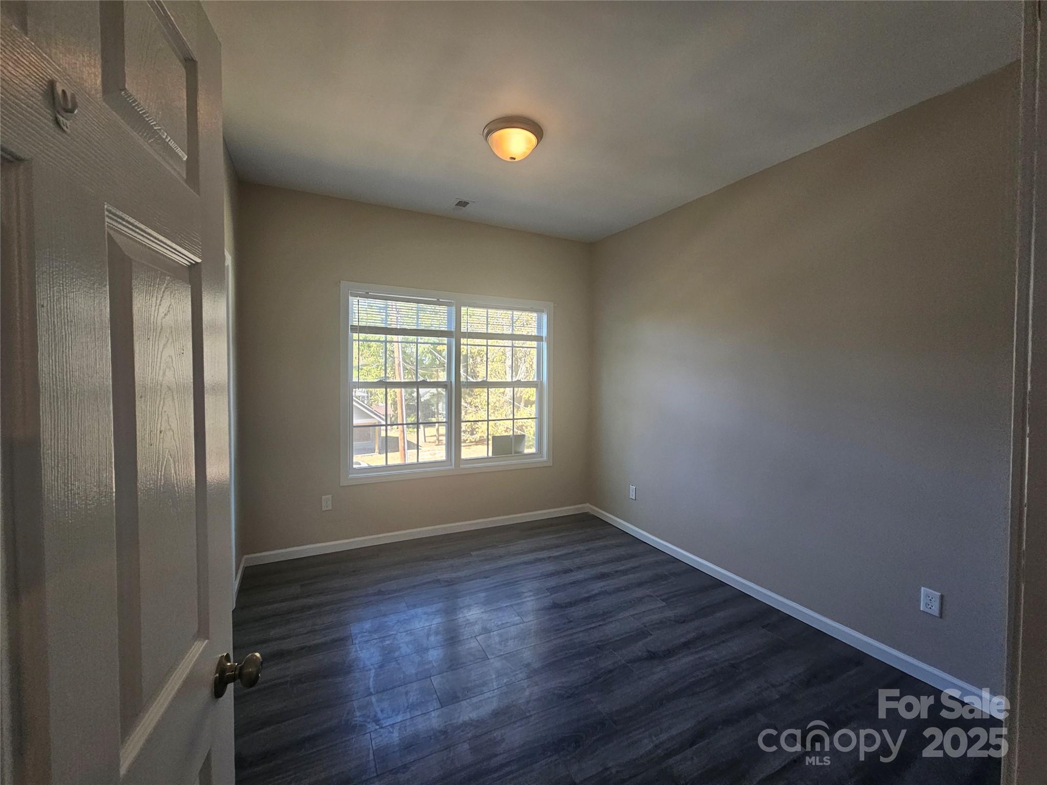 106 Steinkuhler Street, Unit 6 Chester, SC 29706 - Photo 21 of 25 a view of an empty room with wooden floor and a window